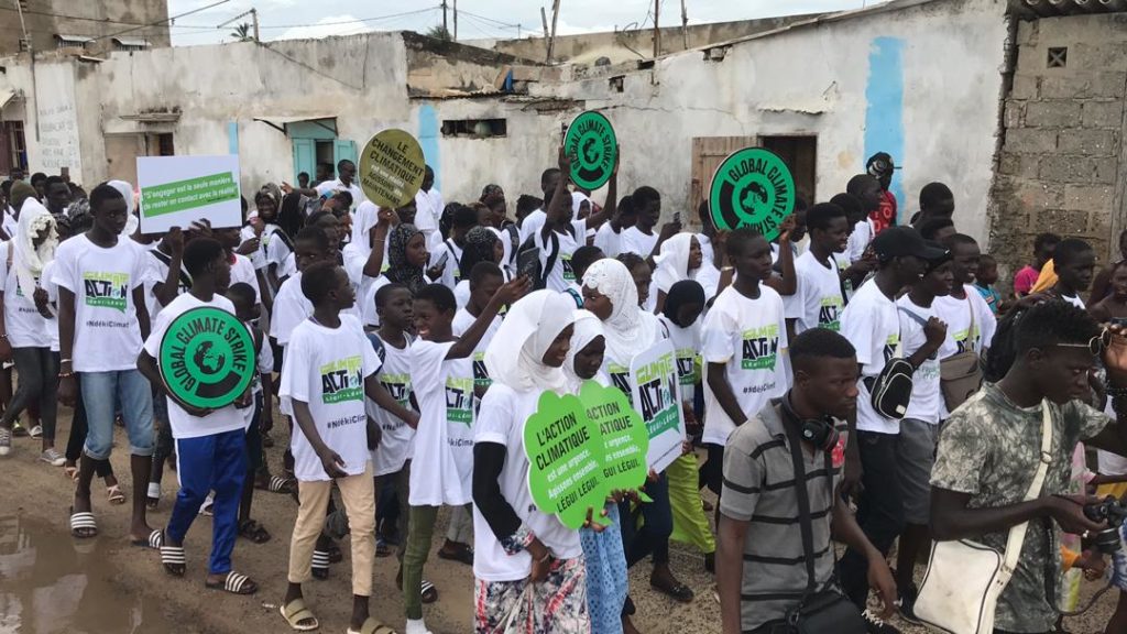 young people protest climate change in the city streets