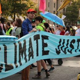 people hold climate justice banner