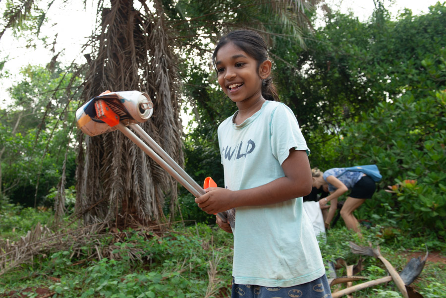Girl picking up trash.