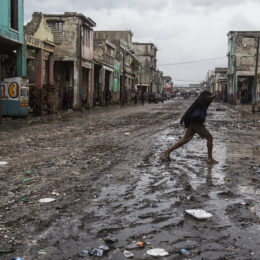 person walks across street in aftermath of hurricane