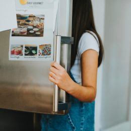 woman opening fridge