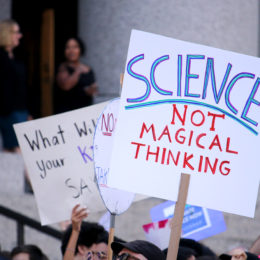 person holding science sign