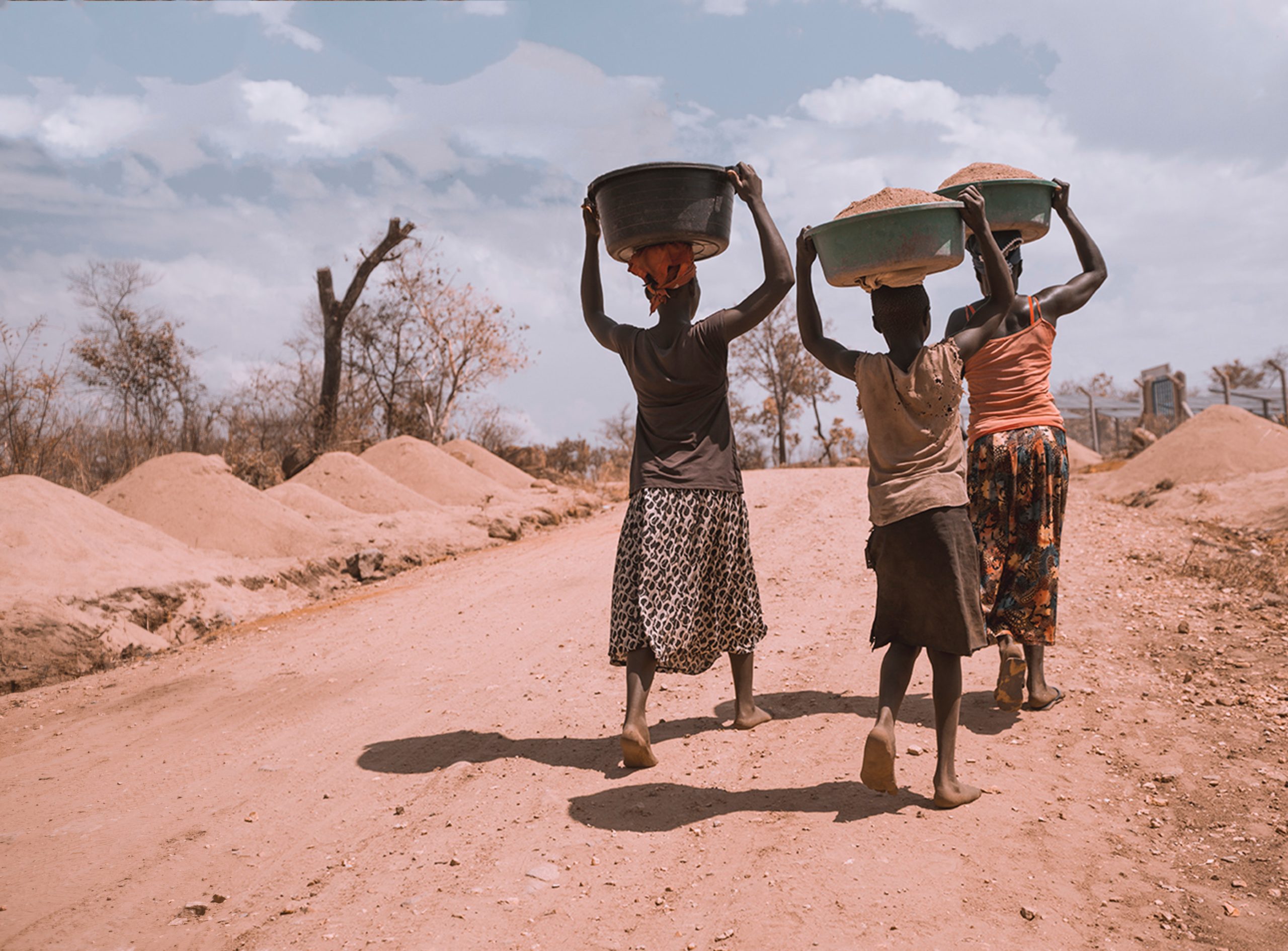 women carrying pots on road