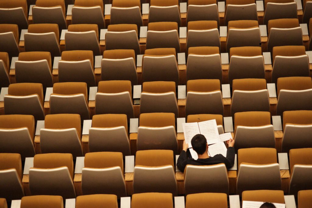 person alone in auditorium