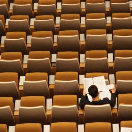 person alone in auditorium