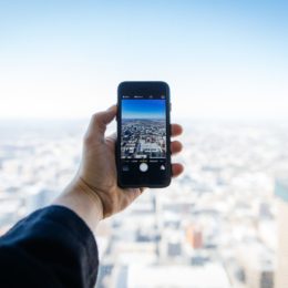 Person taking a photo of the sky on their phone