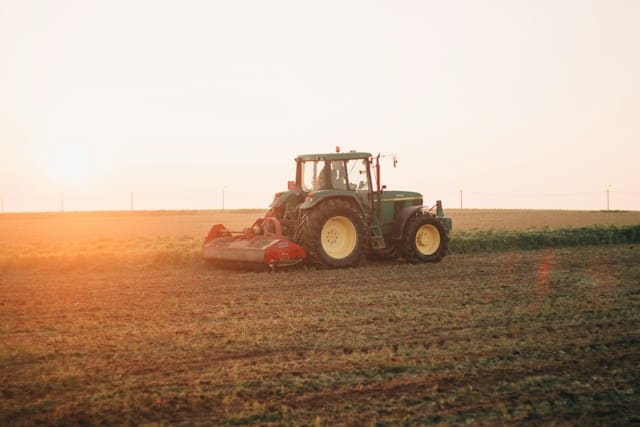Green tractor in a field