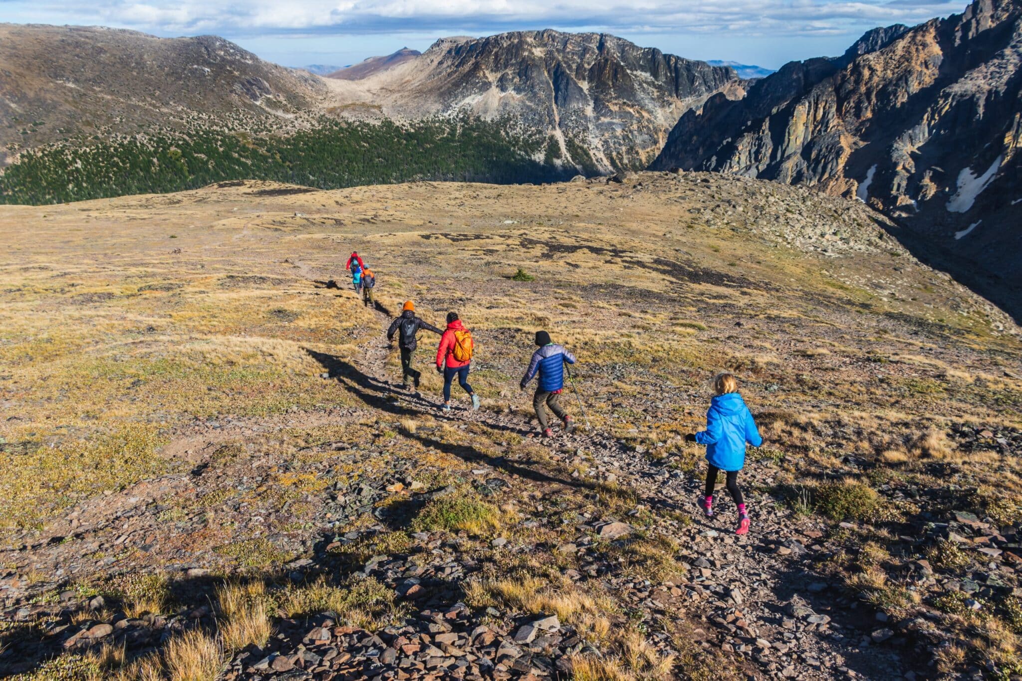 five people hiking in the mountains