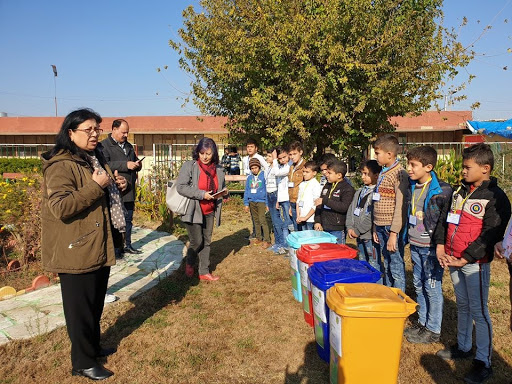 Children listening to a teacher outside