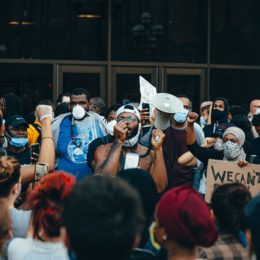 Activist speaking to a crowd with a megaphone