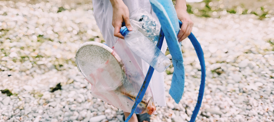 Person picking up Trash on Beach