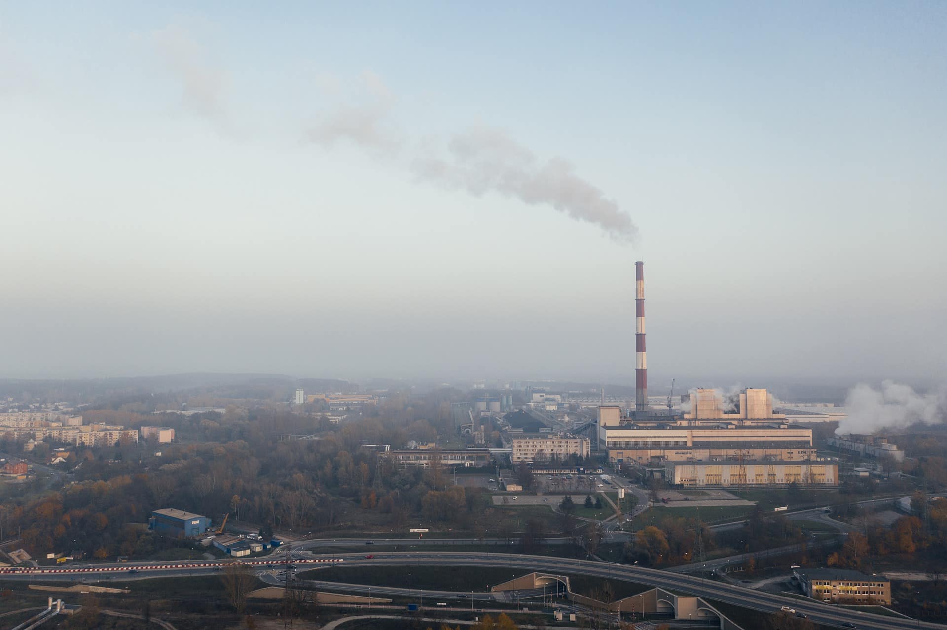 View of a horizon and sky with a factory emitting air pollution