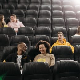 People talking and laughing in a movie theater