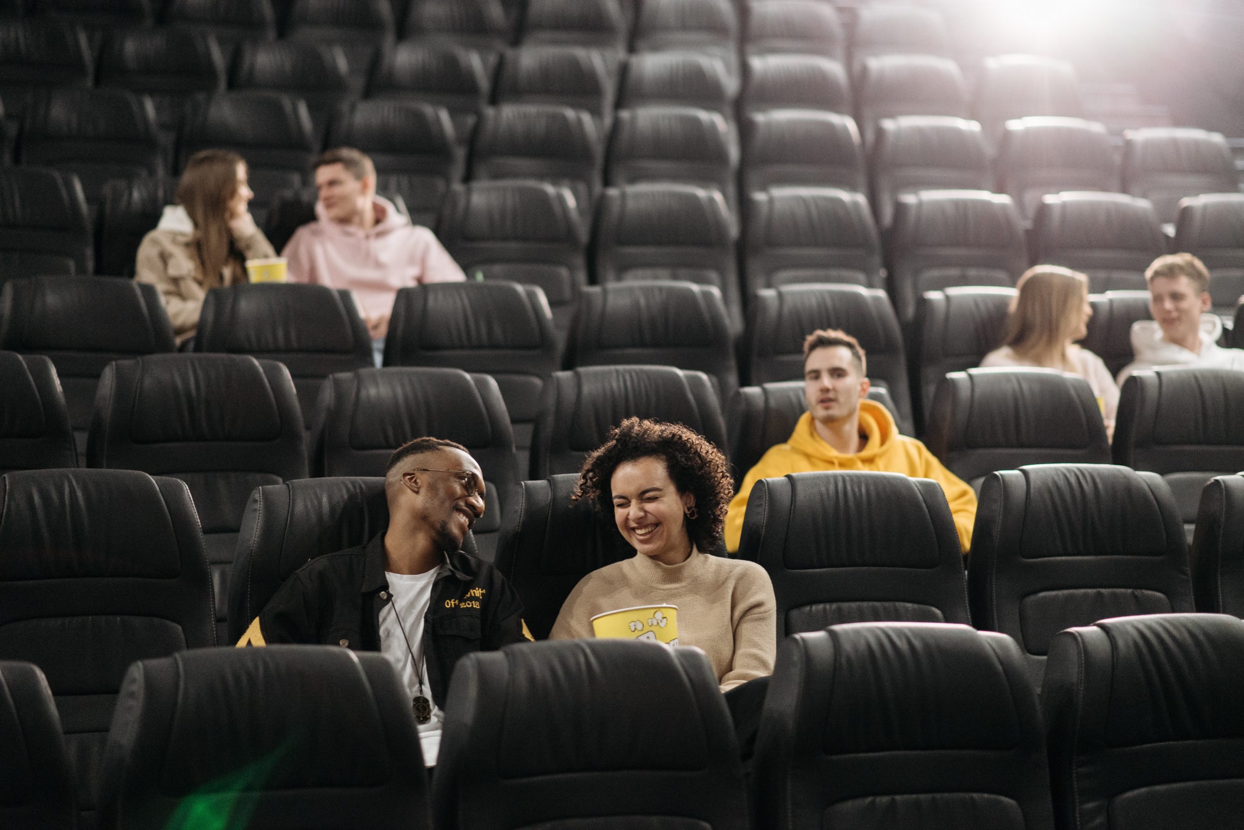 People talking and laughing in a movie theater