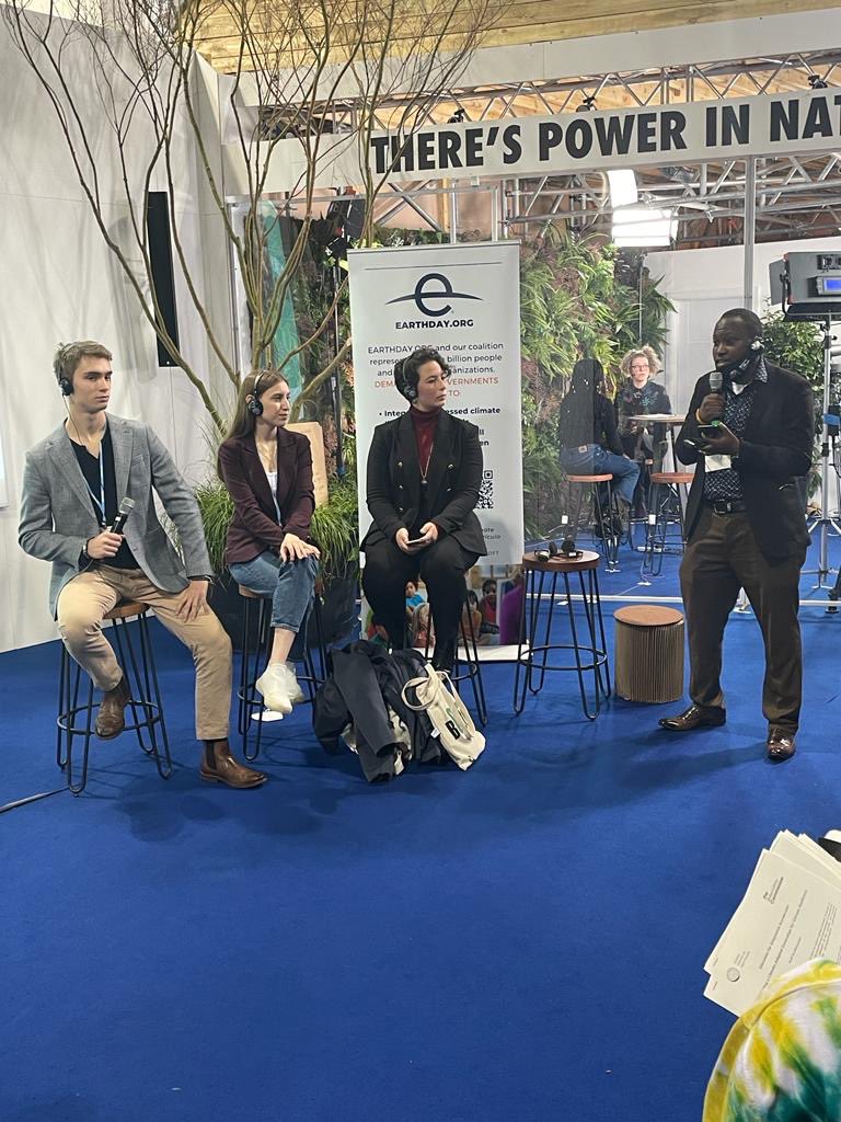 3 people sitting down and watching moderator speak