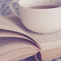 Tea cup set on open book