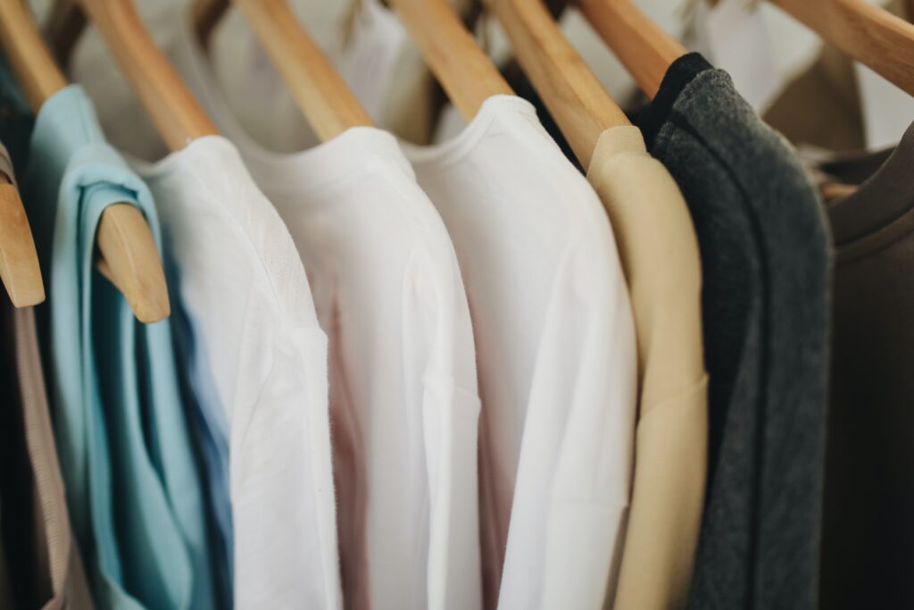 Clothes rack with beige colored shirts