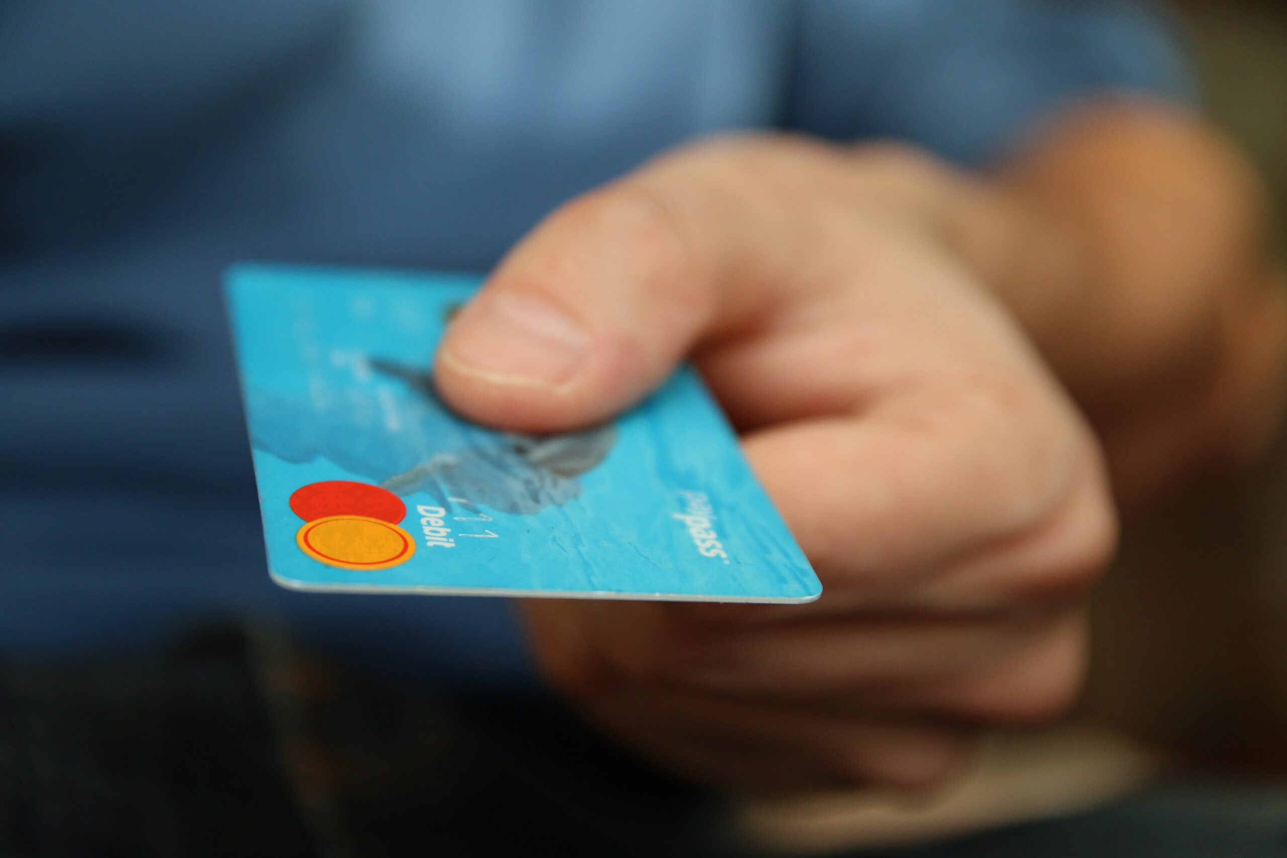 Person holding a plastic credit card