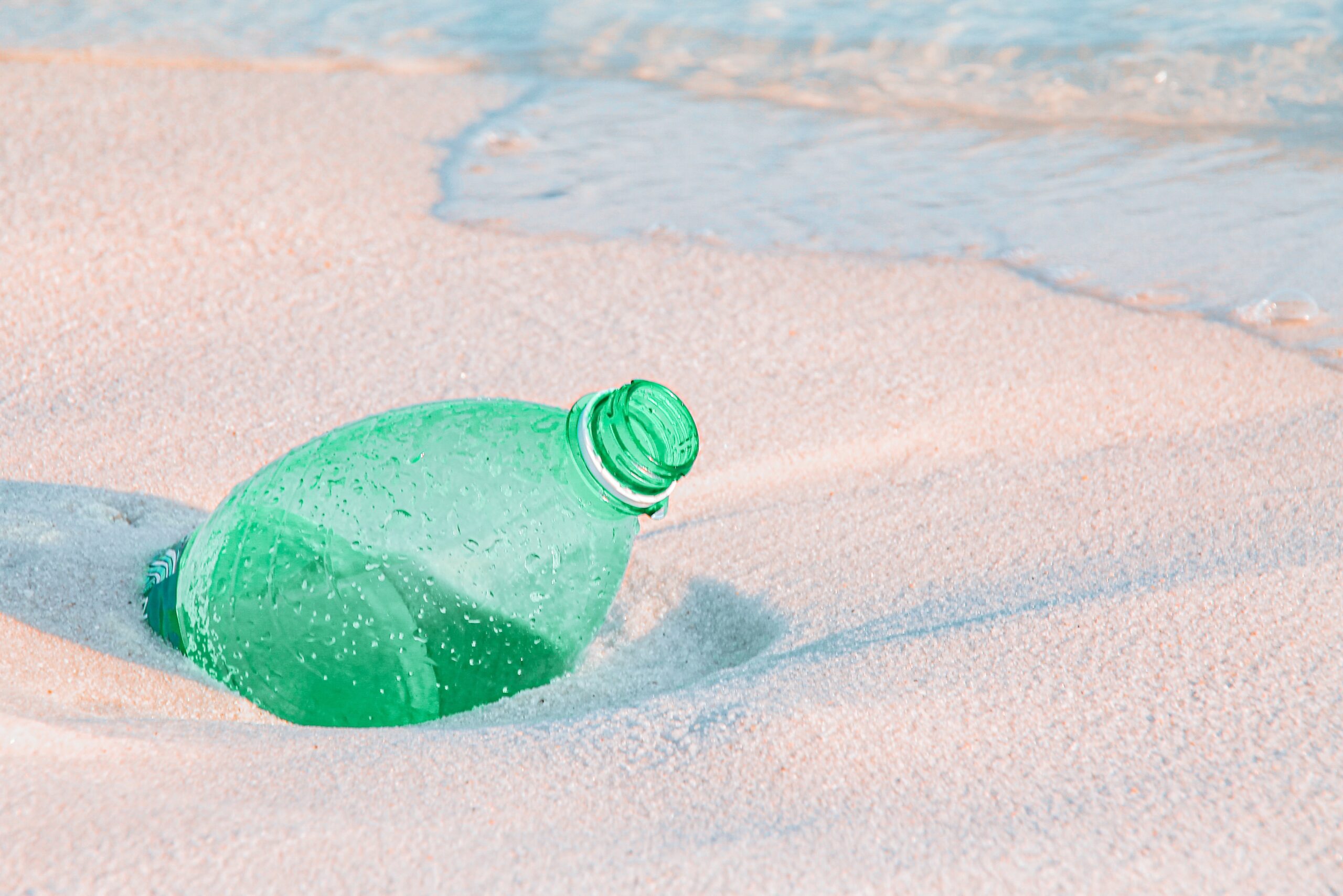 Plastic bottle in sand