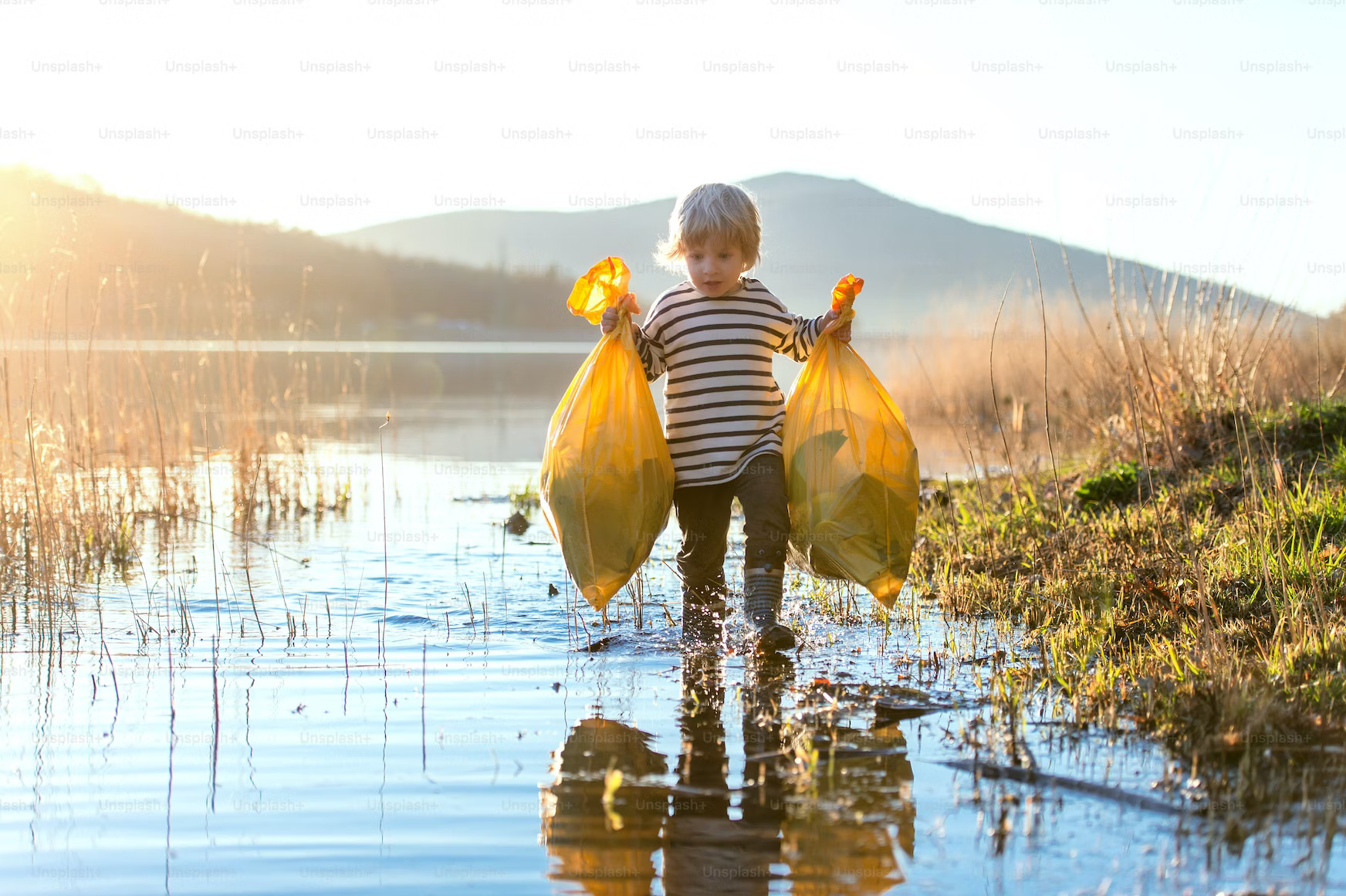 Child picking up plastic pollution