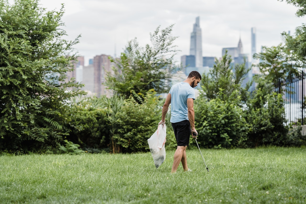 person cleaning up in a city