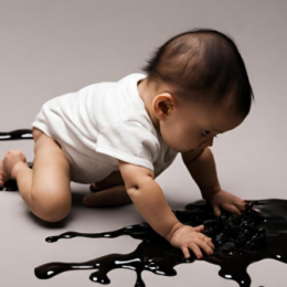baby playing in oil