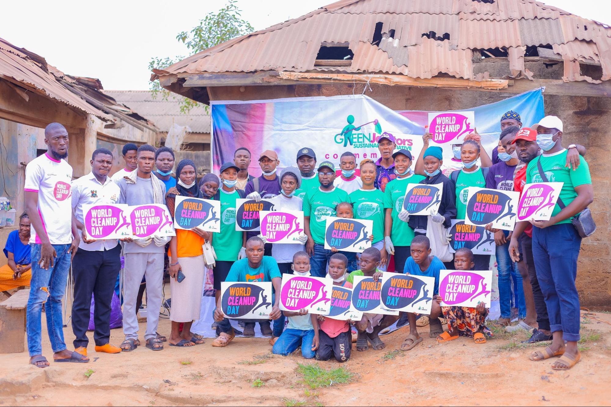 Cleanup volunteers holding up World Cleanup Day signs