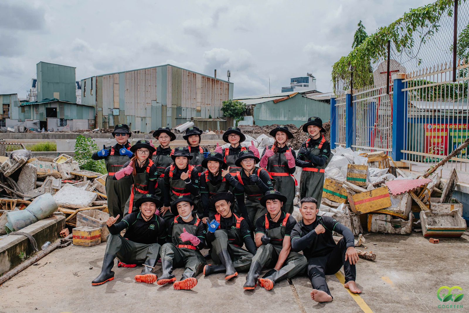 Volunteers posing after the cleanup drenched in water from the canal