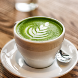 Small cup of matcha with a leaf.