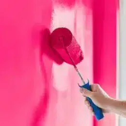 photo of paint roller making a wall pink