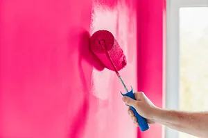 photo of paint roller making a wall pink