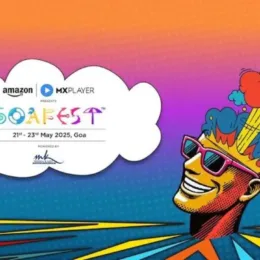 GoaFest poster image of a festival participant with sunglasses and wild hat/image of mind being blown, in a surreal landscape with hot air balloon