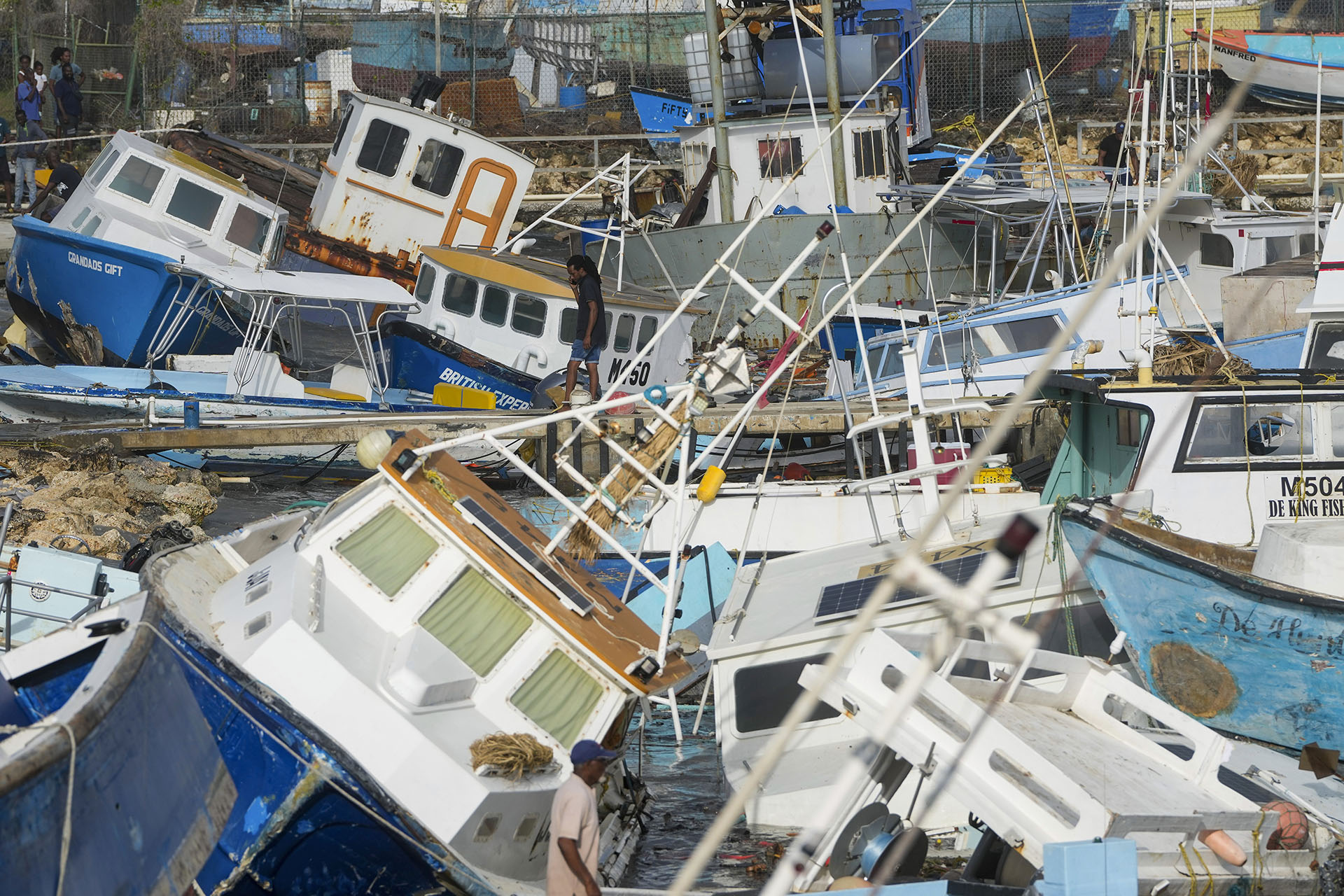 AP photo of AP A fisherman looks at fishing vessels damaged by Hurricane Beryl at the Bridgetown Fisheries in Barbados, on July 1, 2024.