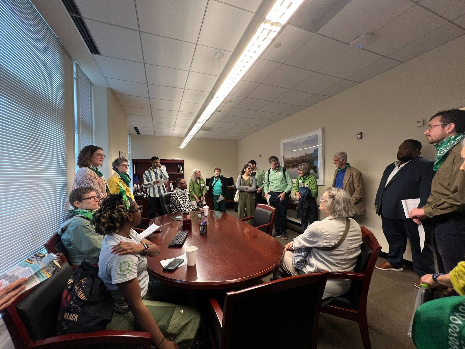 Meeting around a wooden table with Councilmember Felder and the energy advocacy team