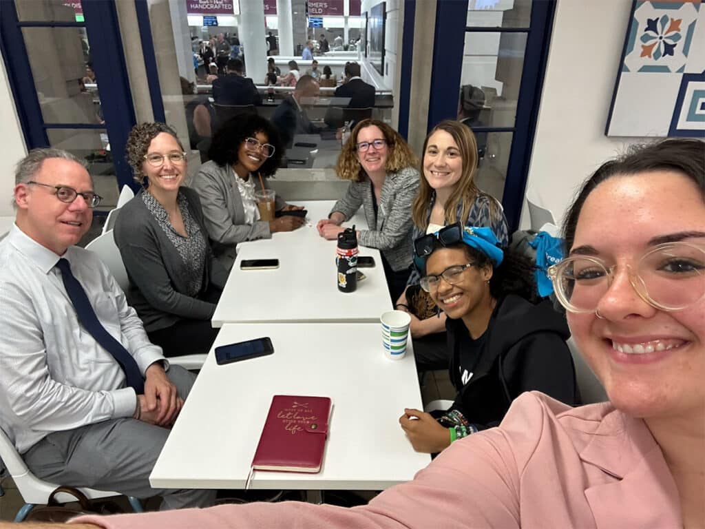 Hill Week Team seated around a table
