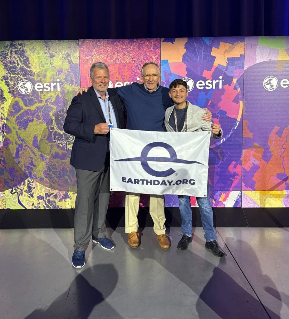 Steve (Left), Jack Dangermond (Center), and Michael (post author) holding an EARTHDAY.ORG banner at the end of the Esri User Conference.