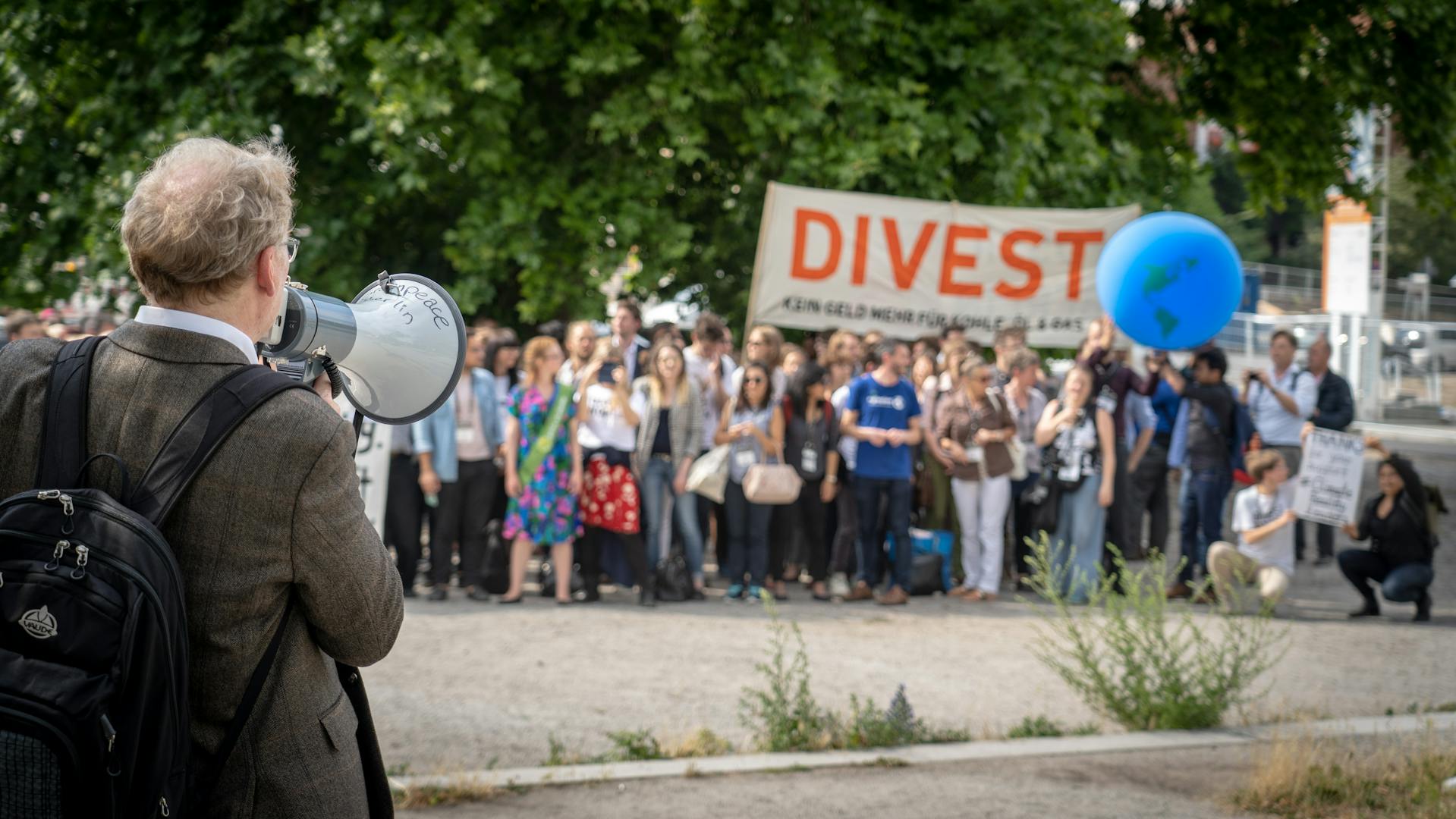 People protesting with a sign to divest