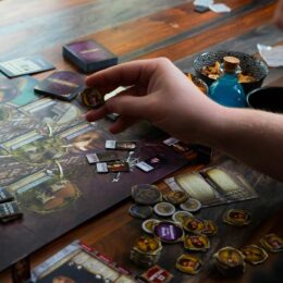 Two hands playing a board game