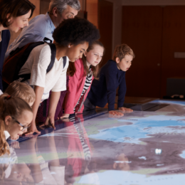 Children leaning over a map