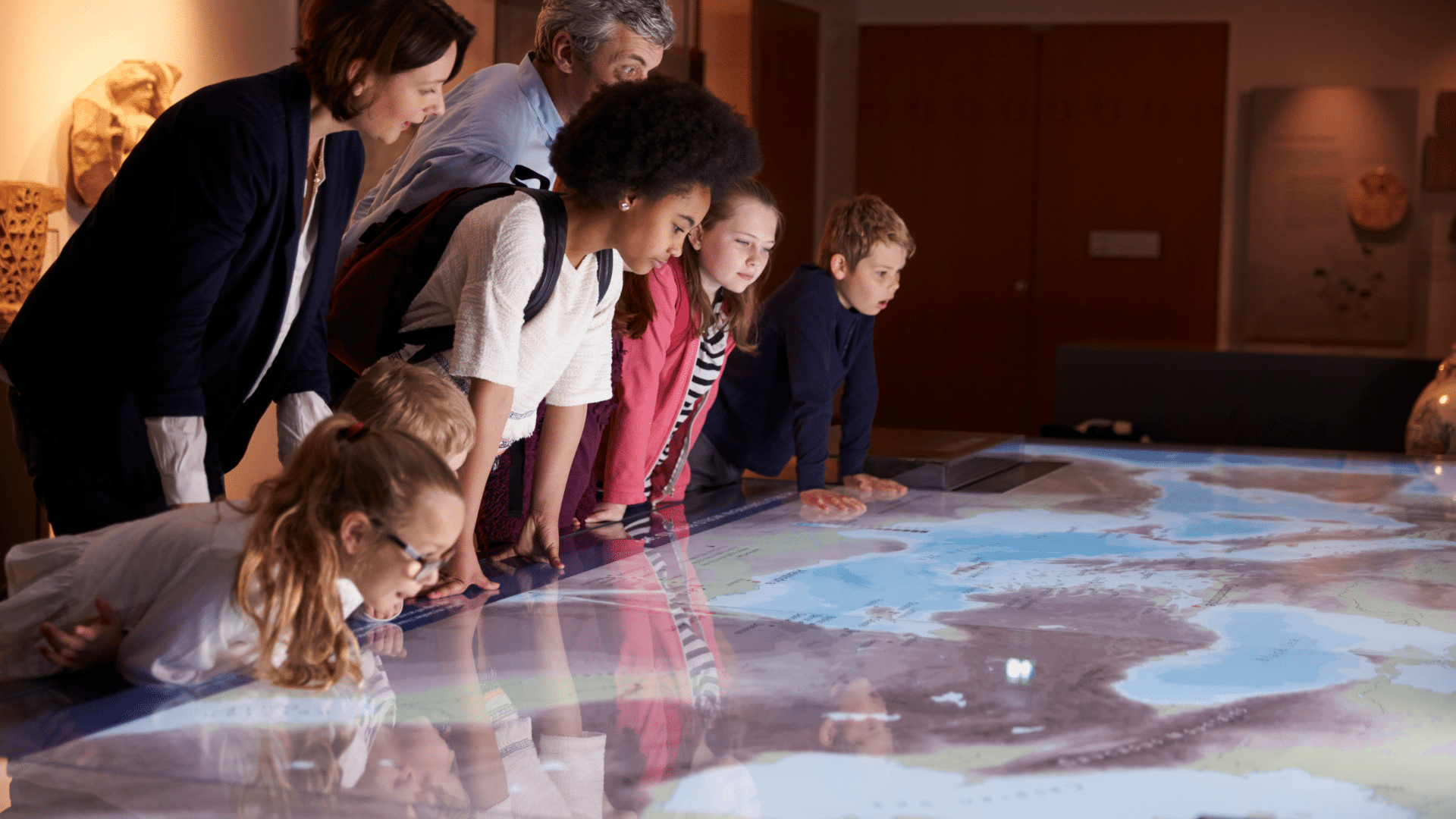 Children leaning over a map
