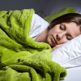 Woman sleeping under a green blanket