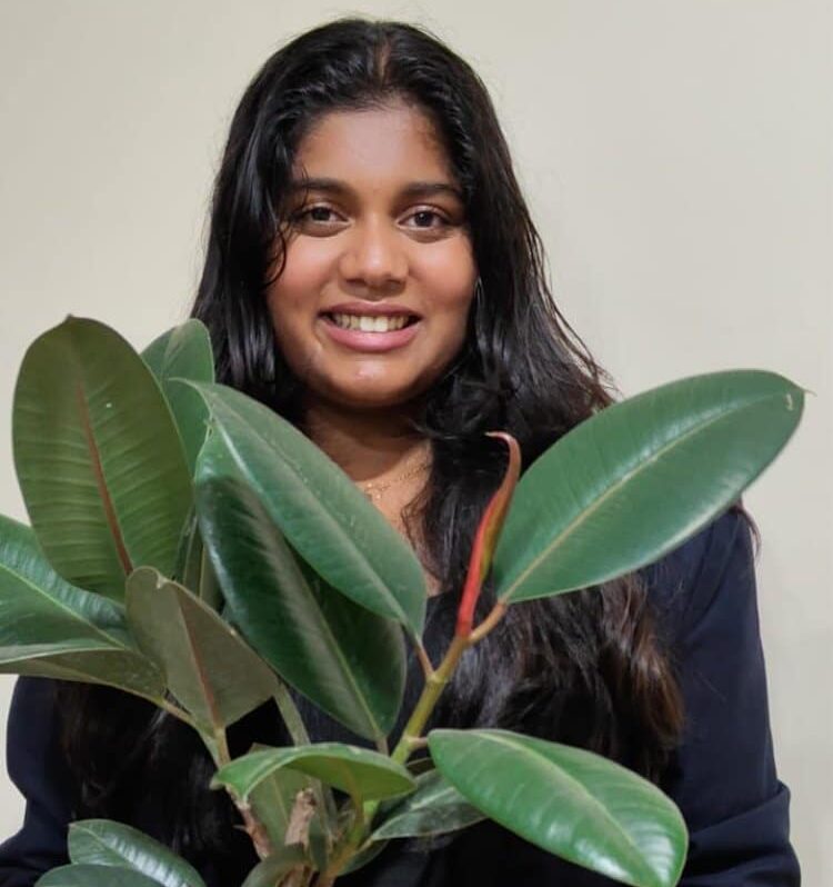 Manya Harsha holding a plant