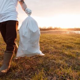Man carrying trash bag