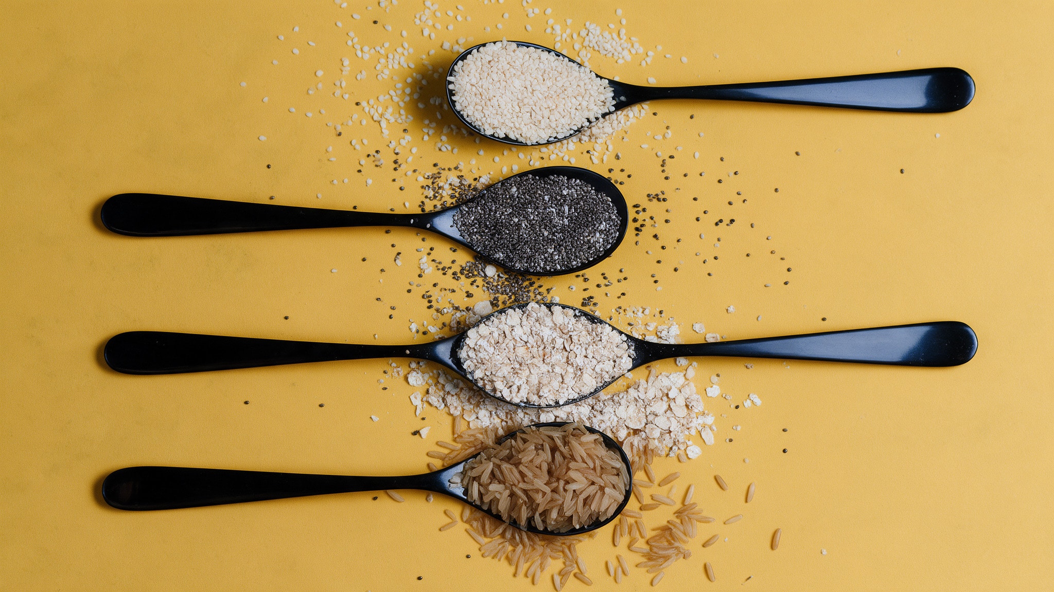 Spoons of seeds, oats and rice