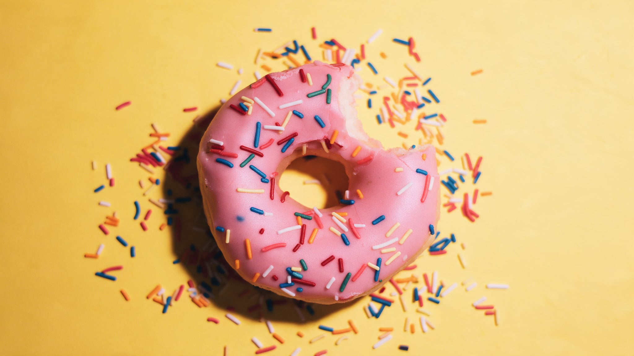 Pink frosted donut with sprinkles