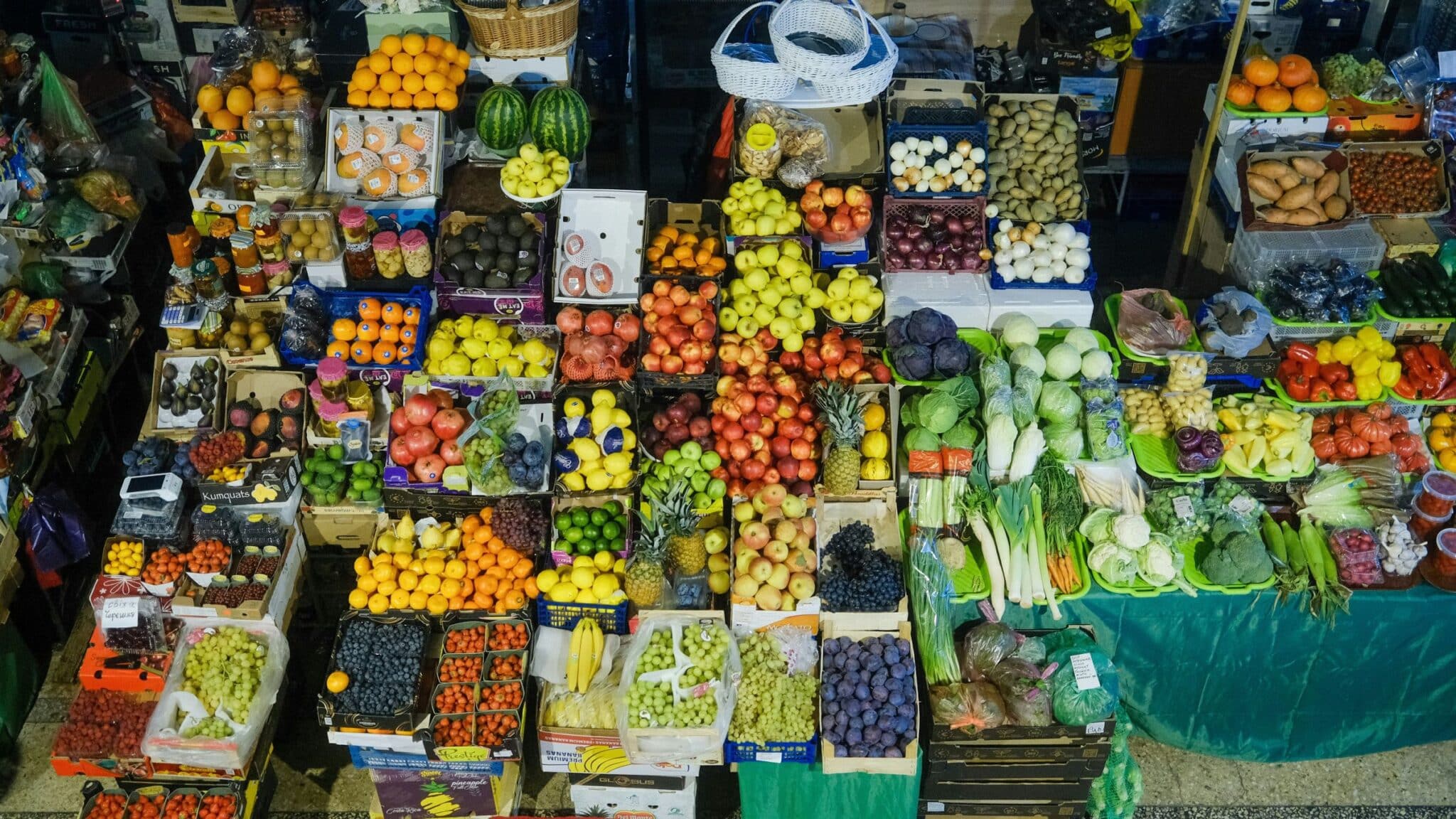 A market stall piled with fresh fruit and vegetables