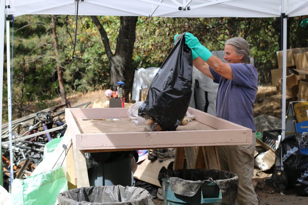 woman empties bag of trash