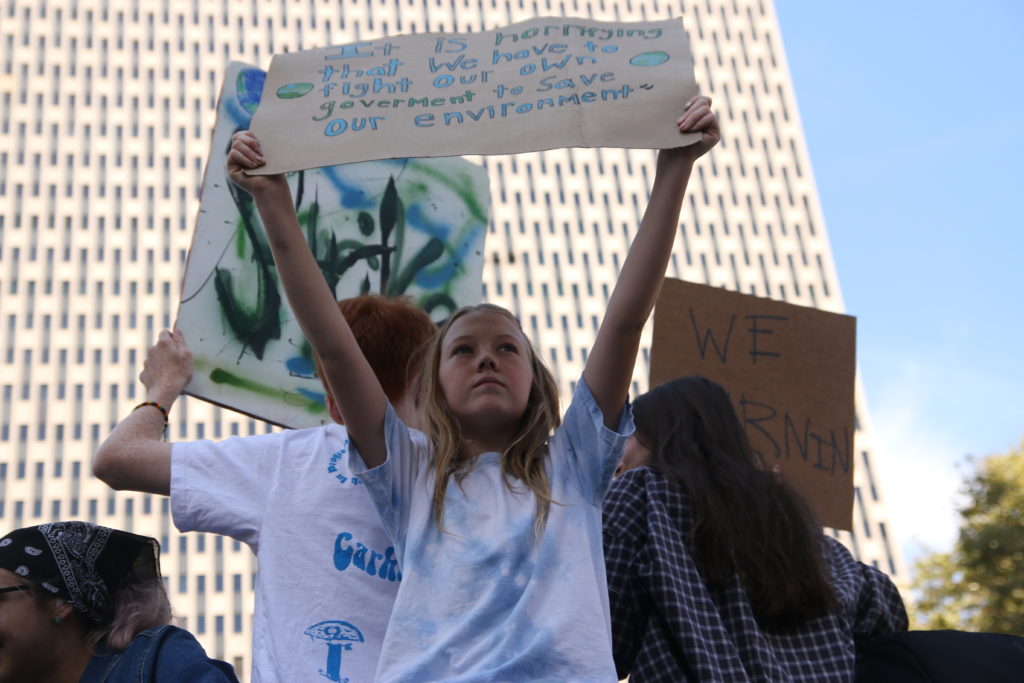 Girl holds sign at rally