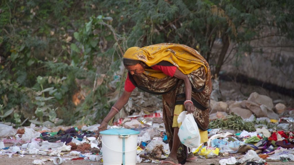 Indian woman picks up plastic